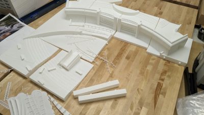 Sections of the 3-D printed scale model of the Memorial being assembled.