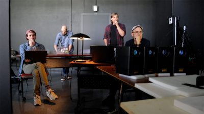 The ICAT team observes final projection testing on the 3-D printed scale model of the Memorial.