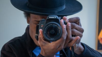 man holding camera in front of his face
