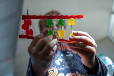Young boy holds a DNA sequence made of candies.