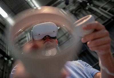 An ICAT Creativity + Innovation Day attendee interacts with a virtual reality environment in the Cube at the Moss Arts Center. Photo by Rodney Kimbangu for Virginia Tech.